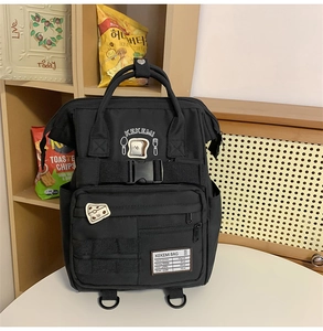 Detail of waterproof nylon backpack with cute cartoon toast patch and buckle strap
