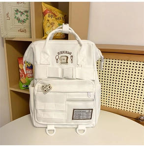 Detailed view of the front pockets and buckles on this white Japanese school backpack