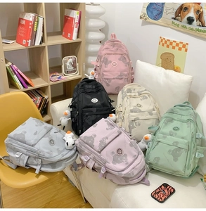 Detailed display of student backpacks with bear prints and decorative duck charms