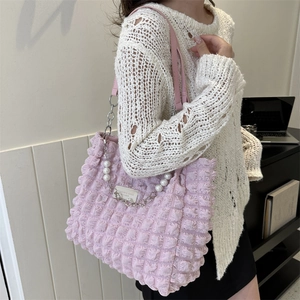 Pink bubble textured shoulder bag with pearl chain details and fashion label