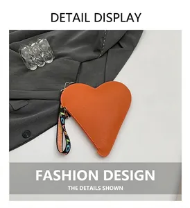Close-up of heart-shaped orange leather coin purse with LOVE rainbow wristlet strap