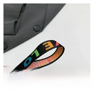 Detail of colorful jacquard woven handle with LOVE lettering on a mini heart bag