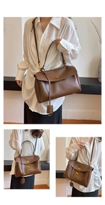 Detail of caramel leather messenger bag with gold square twist lock and shoulder strap
