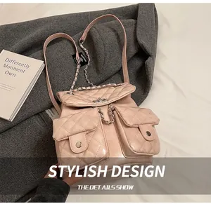 Detail showing pink quilted leather texture and silver chain straps on the stylish backpack