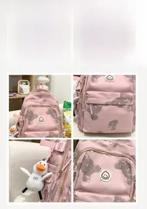 Detailed macro view of pink floral backpack showing water-resistant fabric and plush duck charm