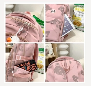 Detail view of pink backpack features breathable handle, side pocket and bear print
