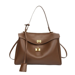 Dark brown matte leather shoulder bag with gold dual twist locks and minimalist design