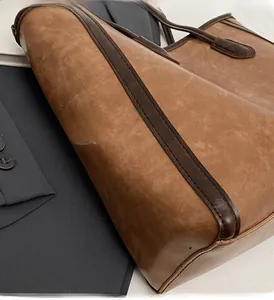 Detail shot of brown vintage leather tote bag edge with dark brown oil edge finish