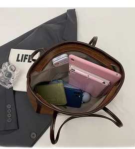 Spacious interior of a brown tote bag showing ample storage for tablets and essentials
