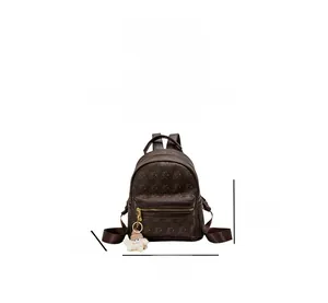 Detailed size view of dark brown bear print backpack with white plush charm