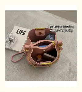 Internal view of pink bucket bag showing large capacity with zipper compartment