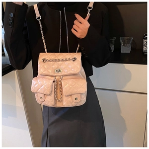Detail of pink quilted leather backpack with silver turn-lock pockets and chain straps