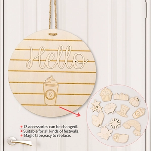Detail of wooden round door sign with 13 interchangeable festive icons and hello text