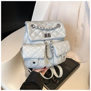 Close-up of quilted grey chain backpack featuring glossy texture and multi-pocket detail