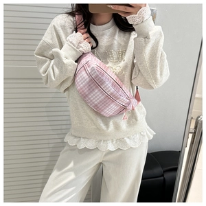Selfie miroir montrant un sac banane à carreaux rose et blanc avec sangle réglable