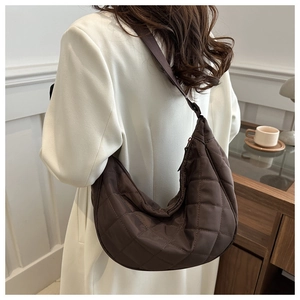 Sac hobo matelassé marron à l'épaule montrant une grande capacité et une texture nylon