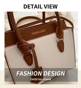 Detail of brown and beige contrast bag with lychee texture and fashion lettering