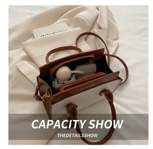 Interior view showing the spacious capacity of this two-tone leather crossbody bag
