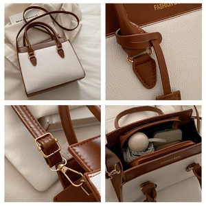Detailed interior of contrast color handbag showing large capacity for phone and wallet