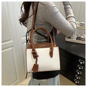Detail of contrast color crossbody bag with leather texture worn by a model