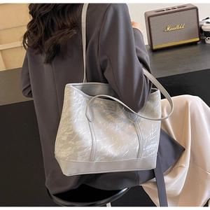 Detail of grey tote bag showing marble texture coating and LUOWENSHA brand logo plaque