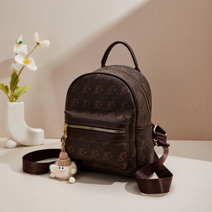 Brown mini leather backpack with bear print and cute monster charm for women