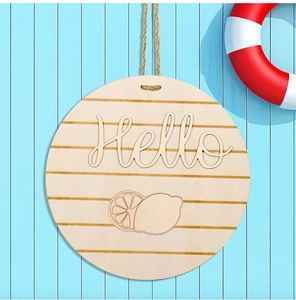 Detail of round wooden door sign with Hello lettering and lemon design on blue background