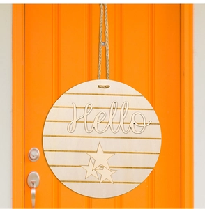 Close-up of a round wooden door hanger with 3D Hello text and gold stripes on orange door