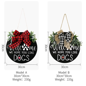 Detail of rustic wooden welcome signs with bows and green foliage for dog lovers