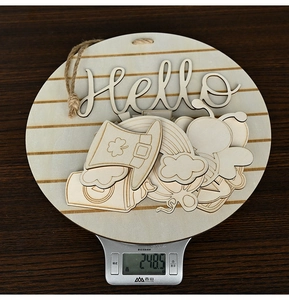 Detail view of DIY round wooden door sign with interchangeable clover and rainbow icons