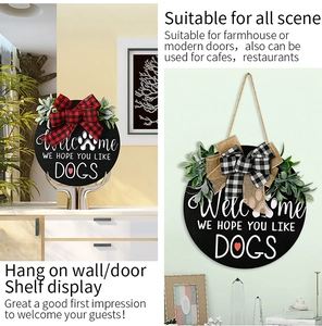 Close-up of a rustic wooden welcome dog door sign with a plaid bow and greenery