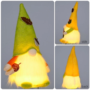 Detail view of glowing Autumn gnome ornament showing front side and back with warm lights
