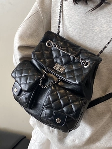 Chic black quilted backpack with metal chain straps and classic turn-lock closure