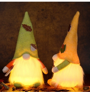 Close-up of lighted autumn gnomes with acorn hats and warm LED fiber optic beards