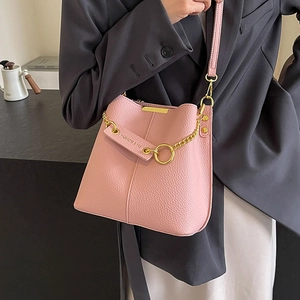 Chic pink lychee texture bucket bag with gold chain and slim leather shoulder strap