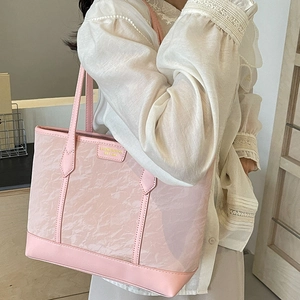Pink textured tote bag with mesh overlay shown as a stylish large capacity shoulder bag