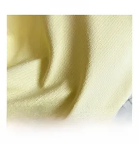 Close-up of pale yellow ribbed knit fabric texture with soft vertical striped patterns