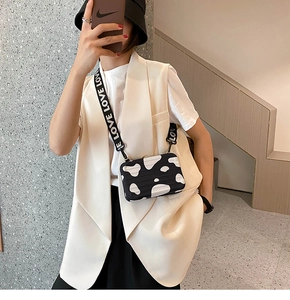 Cow print mini suitcase crossbody bag with a wide LOVE letter strap for casual street style