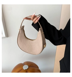 Close-up of oatmeal felt hobo bag showing refined wool texture and golden buckle