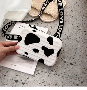 Mini suitcase crossbody bag with cow print pattern and LOVE lettered strap detail