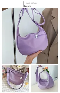 Detail of purple crescent canvas tote bag with adjustable strap and cloud charm detail
