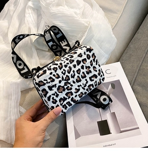 Detail of leopard print hard shell box bag with wide LOVE lettered shoulder strap