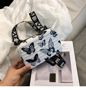 Detail of white butterfly print crossbody bag with ribbed shell and logo strap
