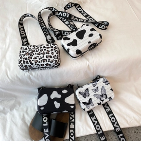 Mini suitcase-style crossbody bags with butterfly, leopard, and cow prints