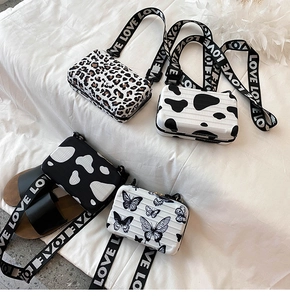Mini suitcase-style crossbody bags with butterfly, leopard, and cow prints and LOVE strap