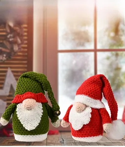 Close-up of handmade knitted Christmas gnomes with textures on a wooden table