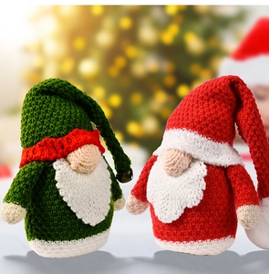Close-up of handmade crochet Christmas gnomes with knit hats and festive bells