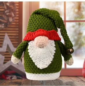 Detailed close-up of a green knitted Christmas gnome with a red hat and metal bell