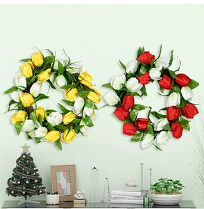 Close-up of artificial tulip wreaths on a vine base hung on a pastel green home wall