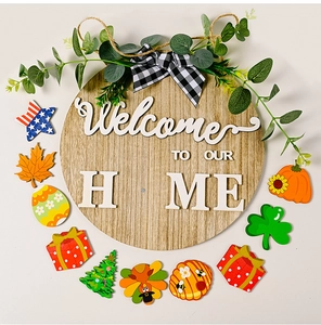 Flat lay of round wooden welcome sign with 10 interchangeable seasonal magnets on white backdrop